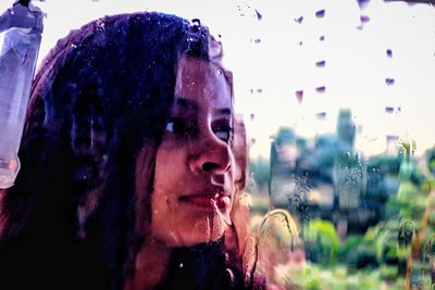 Close-up portrait of young woman looking away