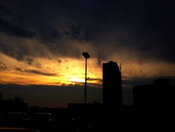 Silhouette of built structure at sunset