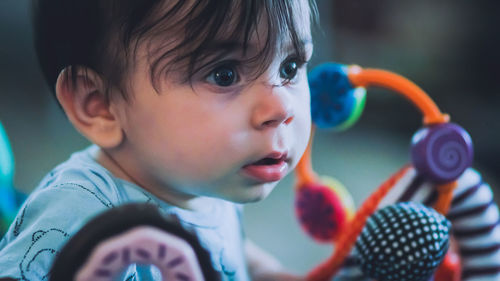 Close-up portrait of cute boy with toy