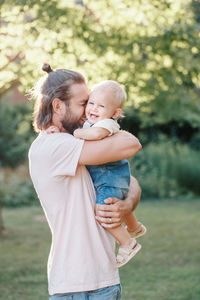 Mother and baby girl standing outdoors