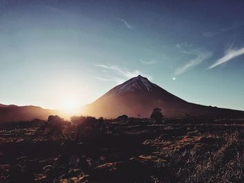 Scenic view of silhouette mountains against blue sky