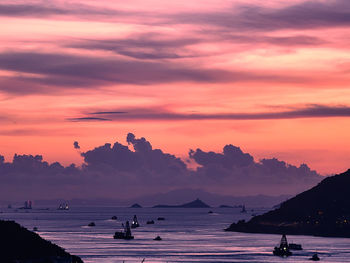 Scenic view of sea against dramatic sky during sunset