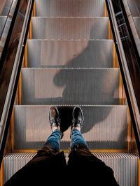 Low section of man on escalator