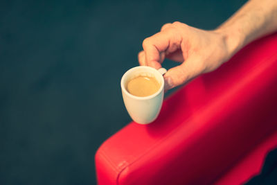 Cropped hand of woman holding coffee