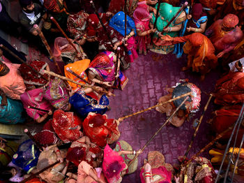 Devotees throw colour powder at each other as they celebrate during the lathmar holi festival. 