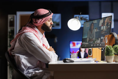 Side view of man working at office