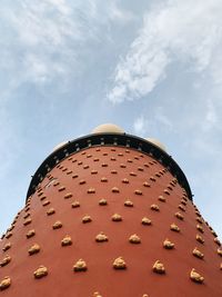 Low angle view of tower against cloudy sky