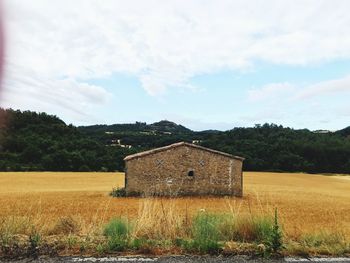 House on field against sky