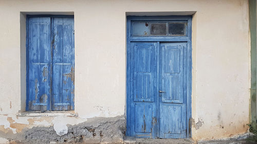 Closed blue door of old building