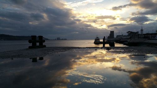 Scenic view of calm sea against cloudy sky