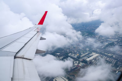 Close-up a wings of a plane aircraft take off from the city-center airfield into the sky