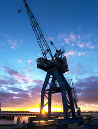 Low angle view of crane against sky at night