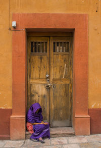 Full length of woman standing by railing