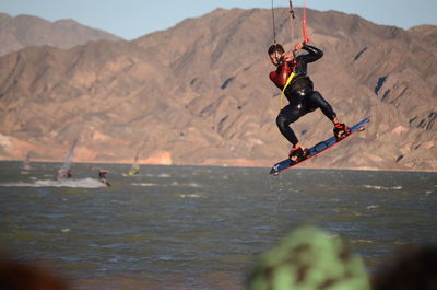 Low angle view of man jumping in lake