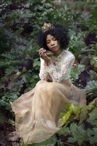 Fantasy portrait of a young woman with a nest in her hands