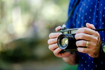 Midsection of woman photographing