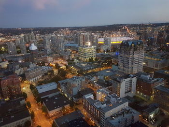 High angle view of illuminated city buildings against sky