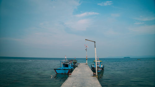 Pier over sea against sky in pahawang island