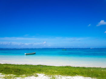 Scenic view of sea against blue sky