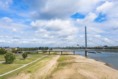 Bridge over road against sky in city