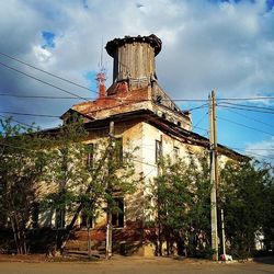 Low angle view of building against cloudy sky