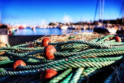 Close-up of fishing net on pier at harbor