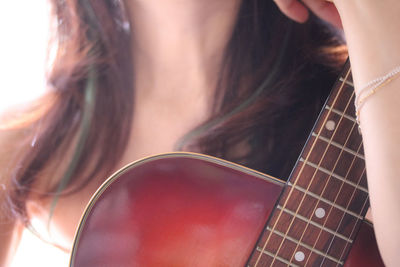 Close-up of woman playing guitar