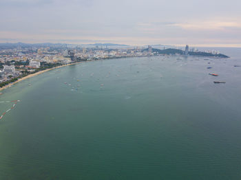 High angle view of buildings by sea against sky