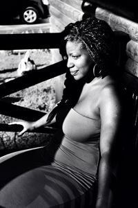 Rear view of woman sitting on bench