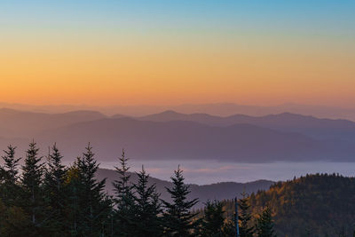 Scenic view of silhouette mountains against sky during sunset