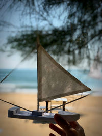 Person holding umbrella against sky