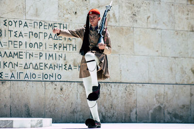 Full length of man standing on wall