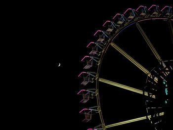 Low angle view of illuminated ferris wheel