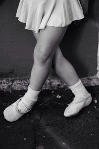 Low section of ballet dance standing on ground