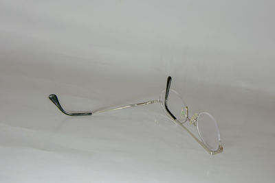 Close-up of eyeglasses on table against white background