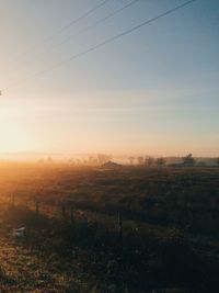 Scenic view of field against sky at sunset