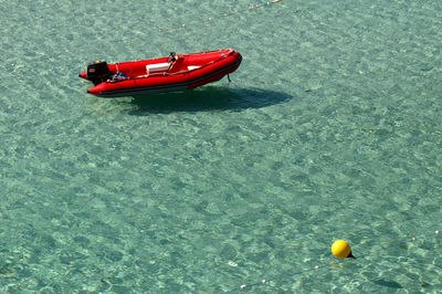 High angle view of red toy floating on water