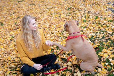 Woman in autumn leaves