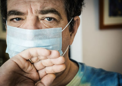 Close-up portrait of man in medical mask