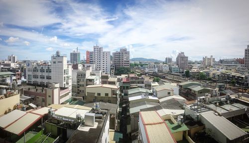 High angle view of city against cloudy sky