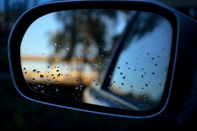 Close-up of side-view mirror of car