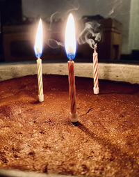 Close-up of lit candles on birthday cake