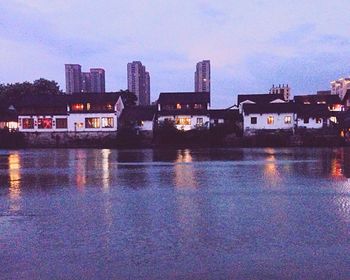 River in front of buildings at dusk
