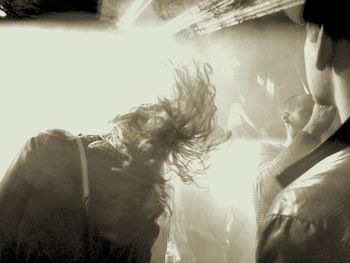 Rear view of woman enjoying at concert