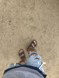 Low section of woman standing on ground