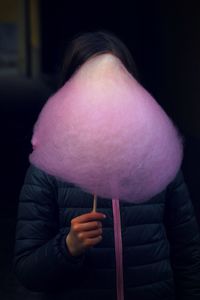 Woman with face covered by cotton candy