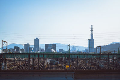 Buildings in city against clear sky