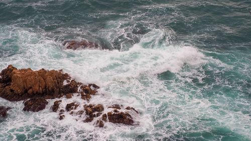 Waves splashing on rocks at shore