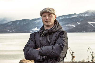 Portrait of young man standing in snow