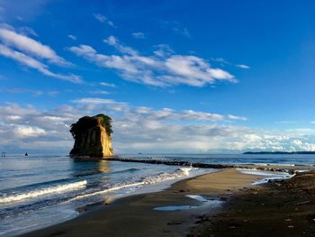 Scenic view of beach against blue sky